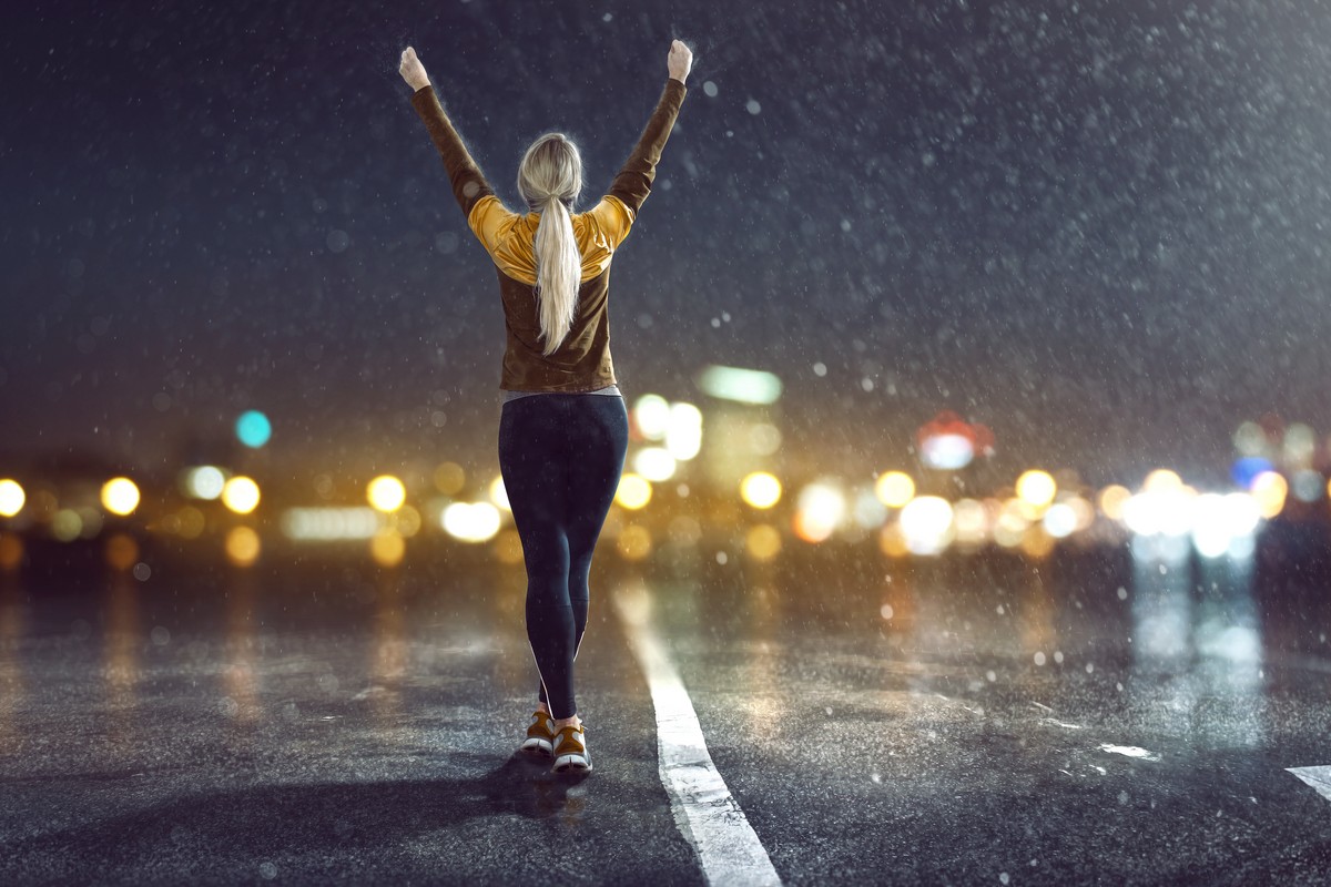 Successful Runner in the rain on a road